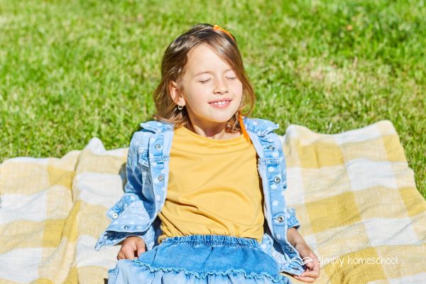 Child sitting in the sun: Advice for simplifying homeschooling from Simply Homeschool