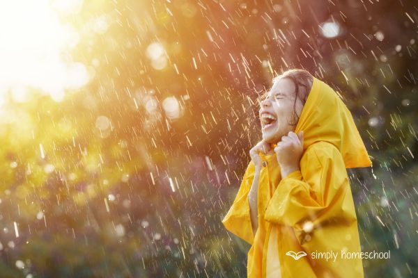 Girl in a raincoat playing in the rain: Advice for simplifying homeschool from Simply Homeschool